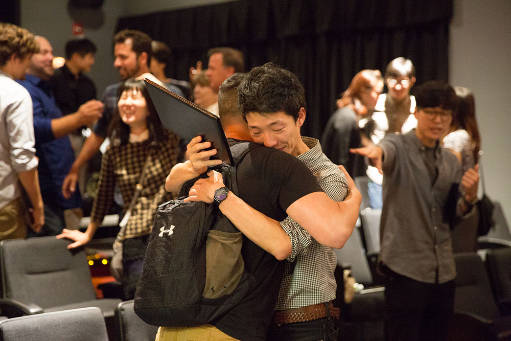 two people hugging at the 2016 nyfa fall film commencement ceremony