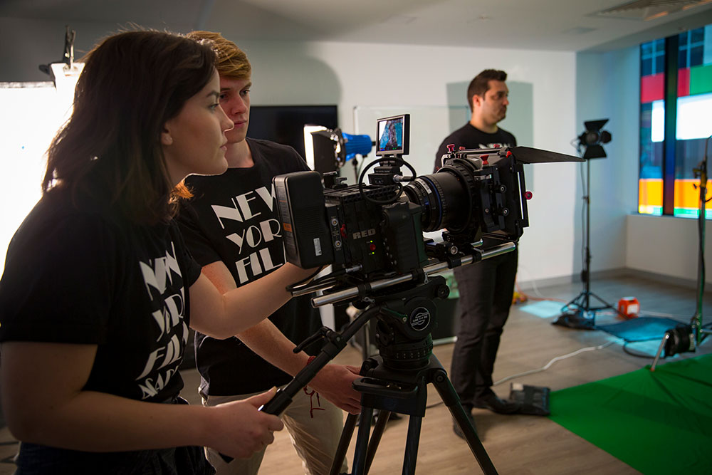 two nyfa students looking through camera