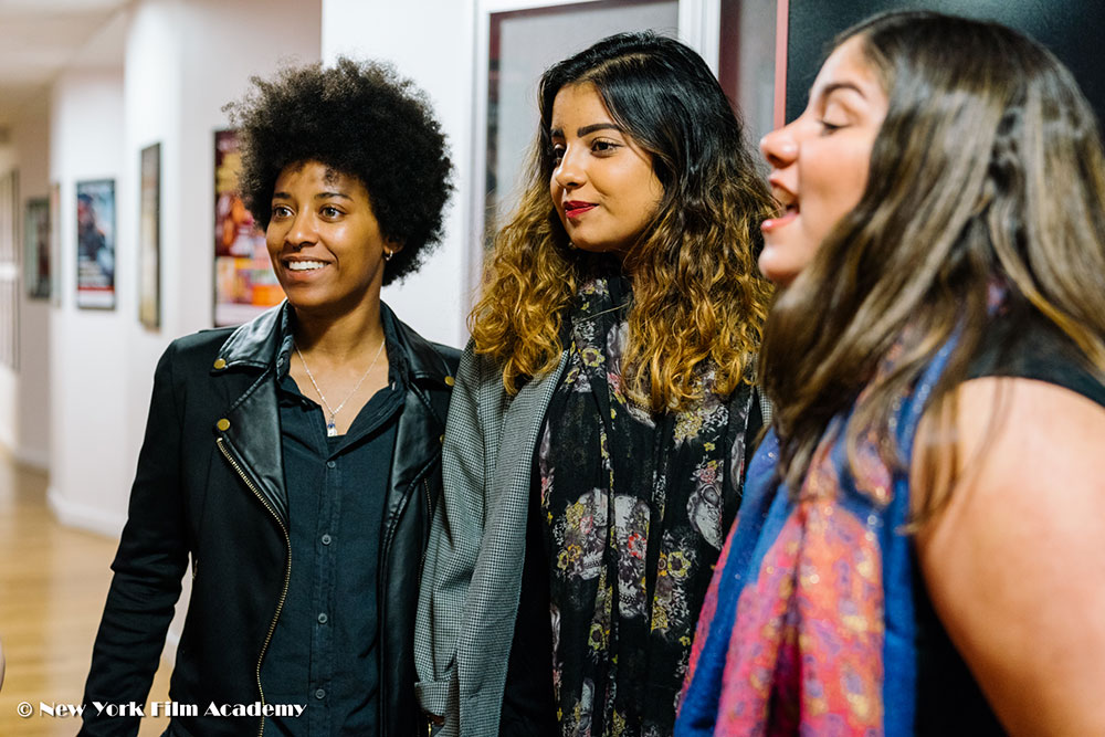 Three students talking at the NYFA LA Alumni Industry Showcase.