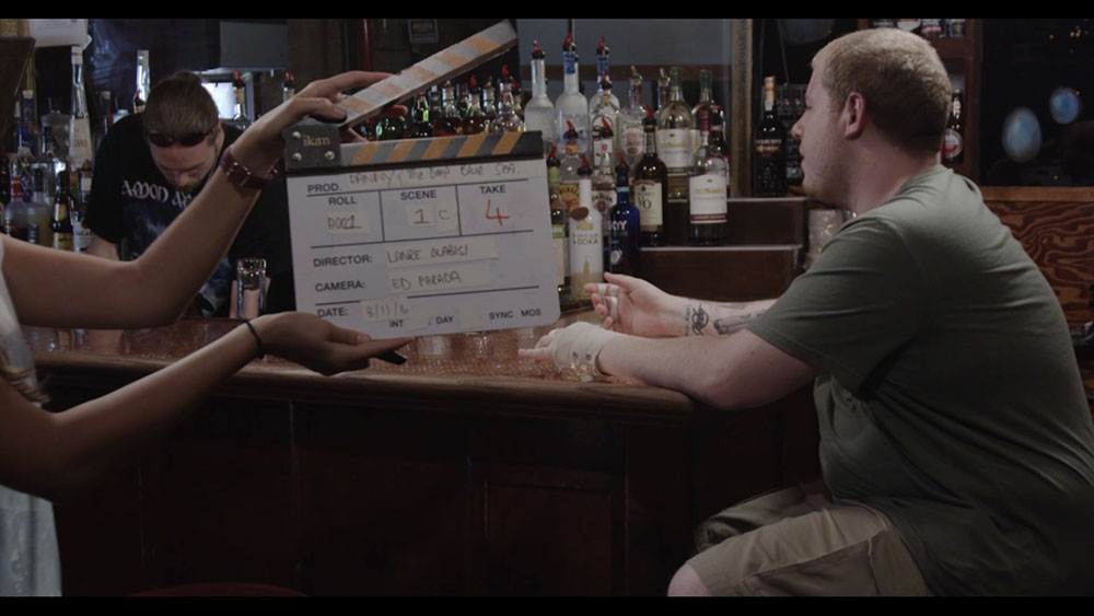 NYFA Final Scene Stills moves still of clapperboard in front of bar scene.