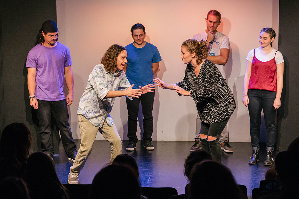 NYFA LA play actors performing scene on stage in front of a crowd.