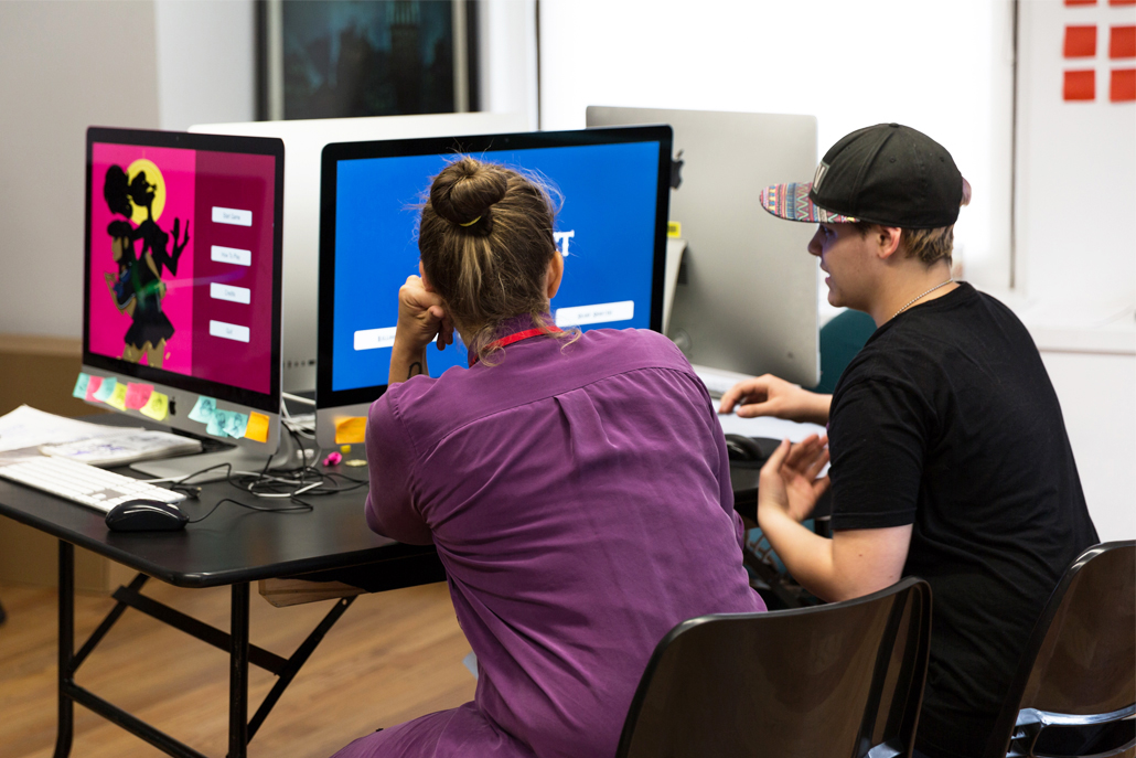 Woman and man looking at a computer