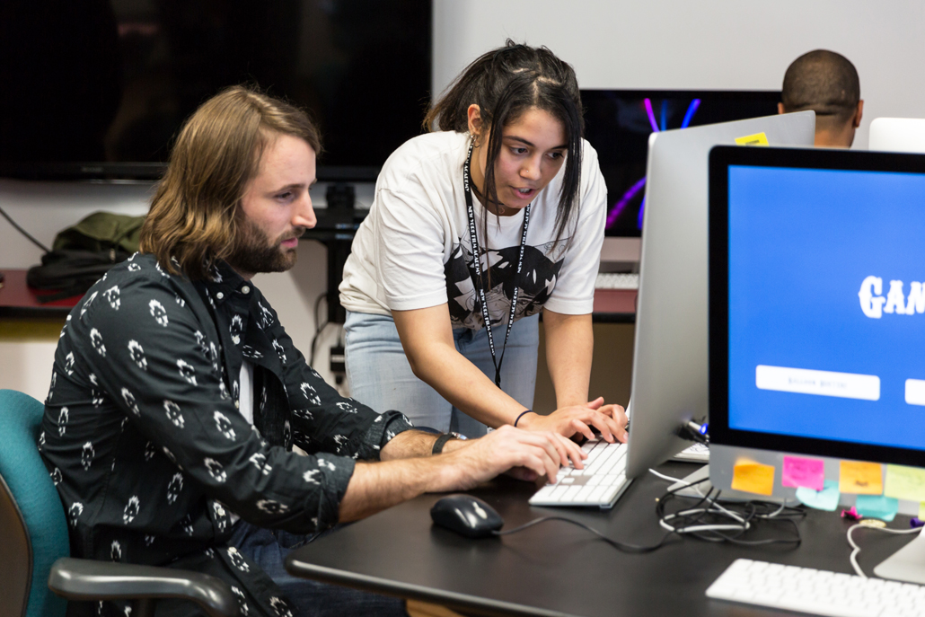 Student helping student with a computer