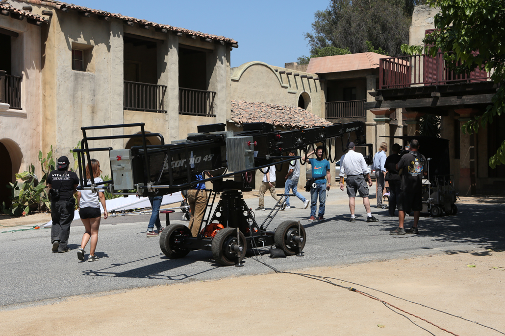 A camera crew setting up outside a house