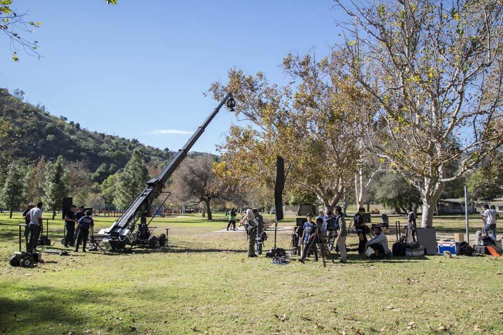 Camera crew setting up in a park