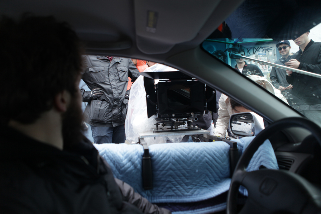 Close-up of side car camera rig from inside the car