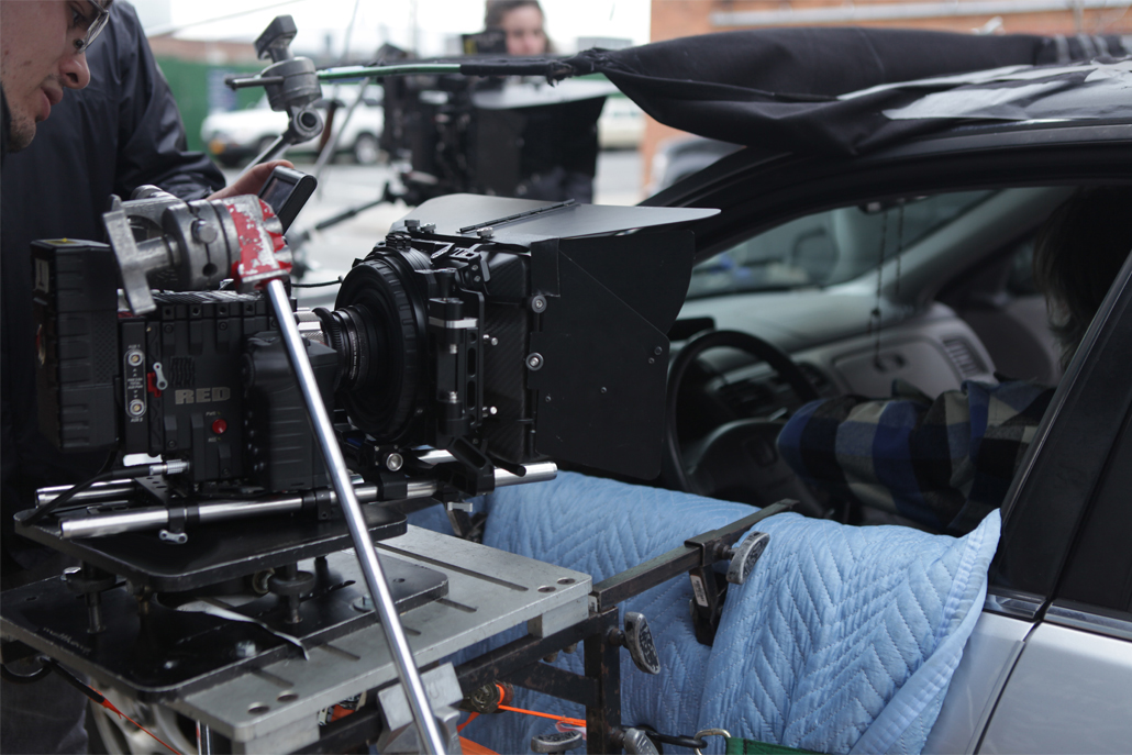 Close-up of side car camera rig from outside the car