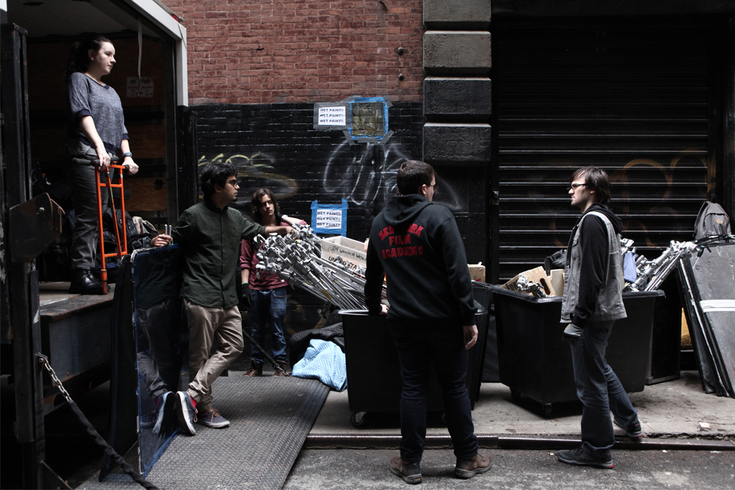 Crew members unloading equipment from truck