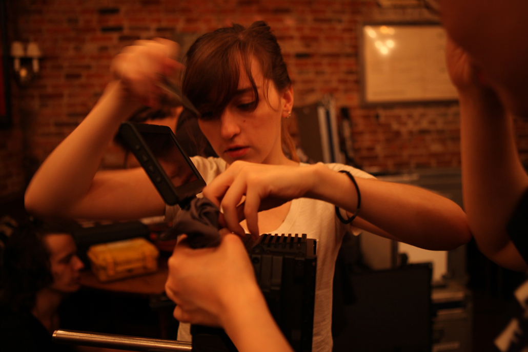 A woman setting up a camera