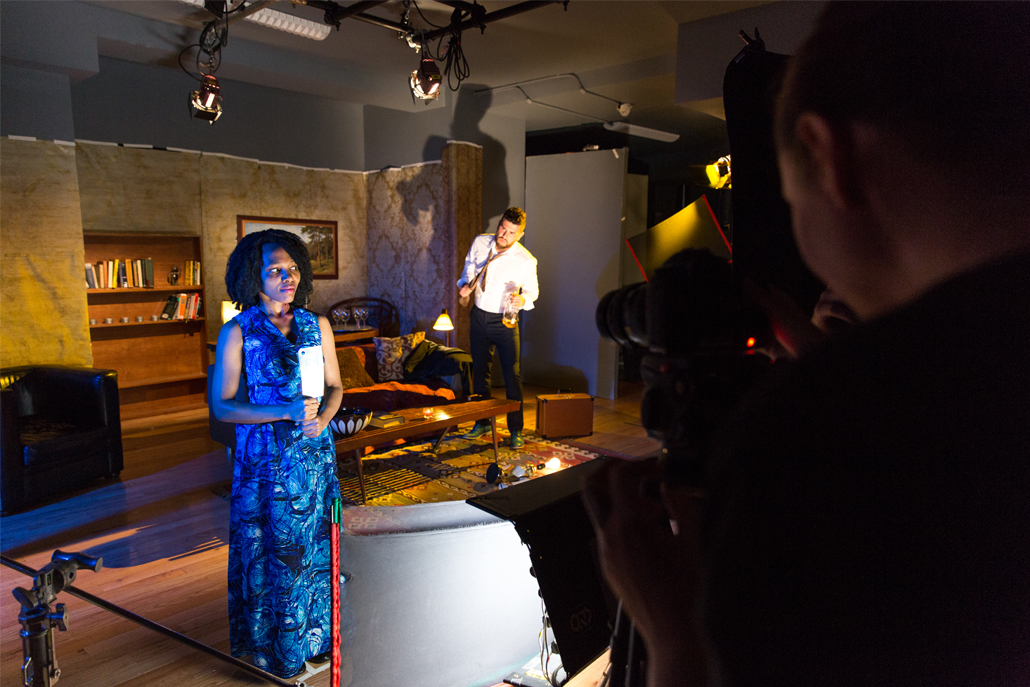 Camera man filming a man and woman on stage