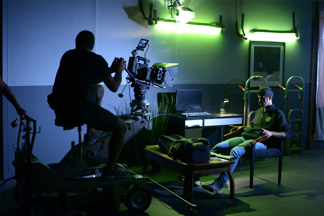 Camera man filming a man in a chair 