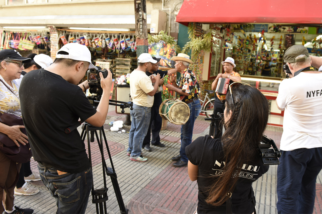 Film crew recording music performers on streets of Dominican Republic