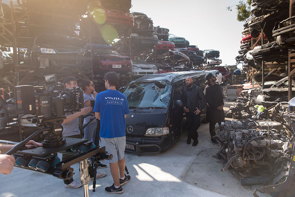 nyfa students filming scene in junkyard