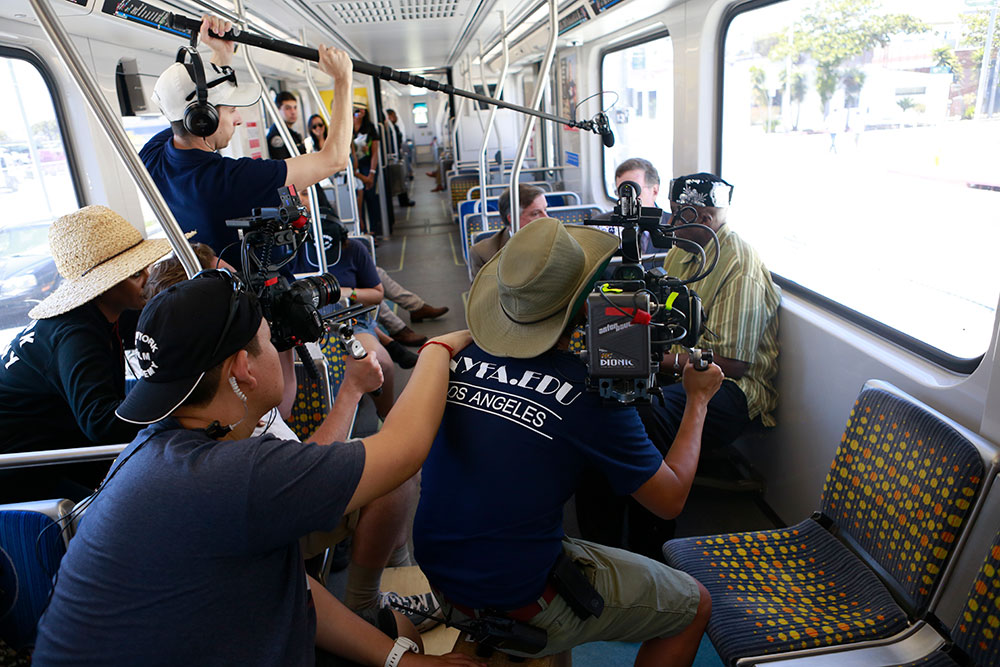 group filming people on train