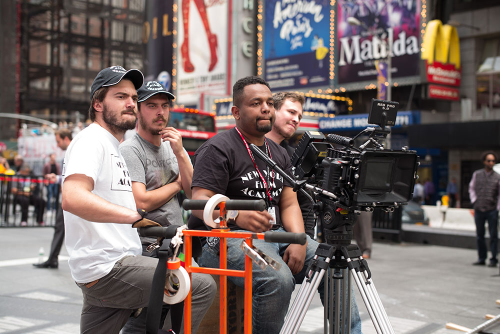 four new york film academy students directing a scene in times square