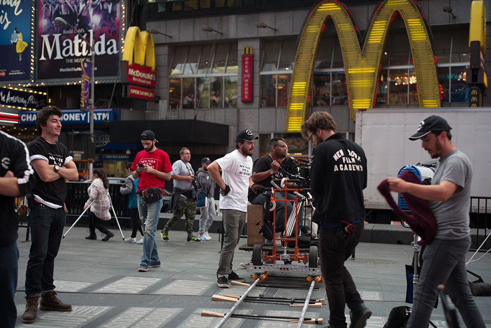 group of nyfa students directing a movie scene in times square