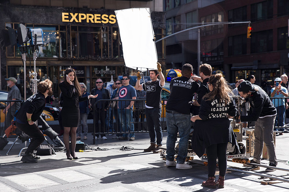 students filming girl in times square