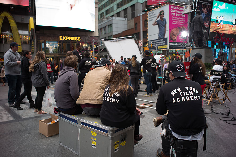 group of nyfa students watching a scene in times square