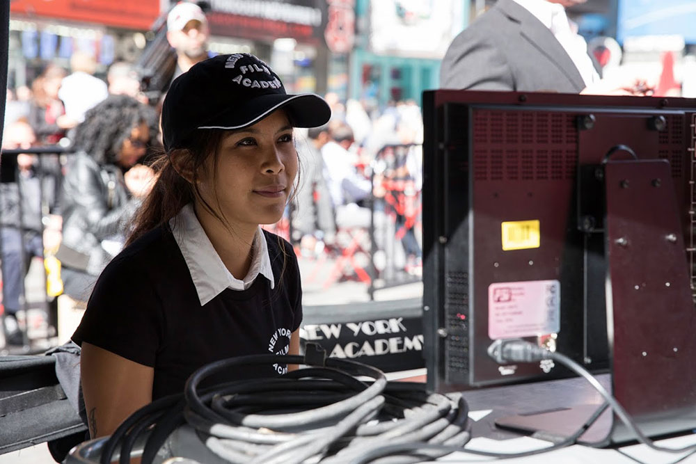 girl watching playback of scene on set