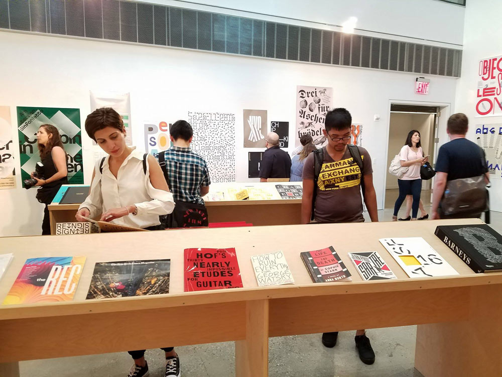 People flipping through different magazine displays