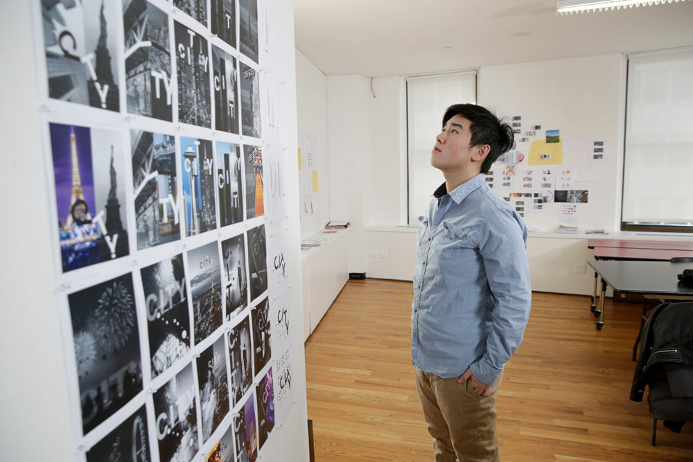 A student standing next to the project board