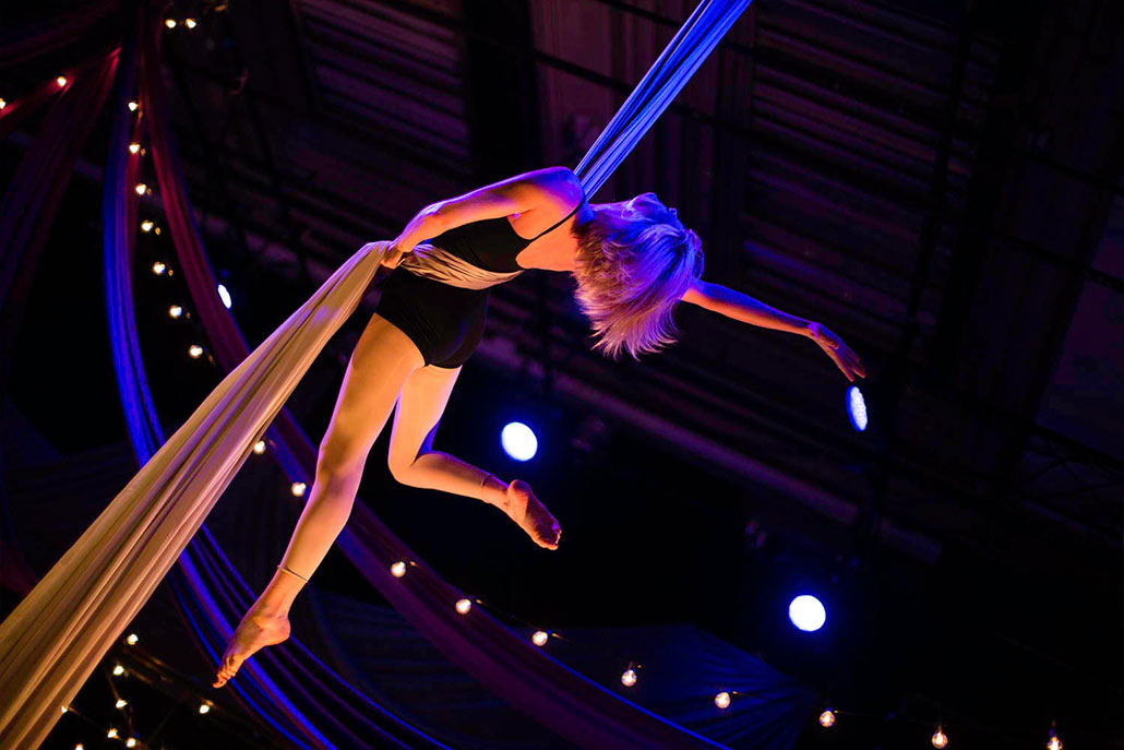 girl hanging from rope performer