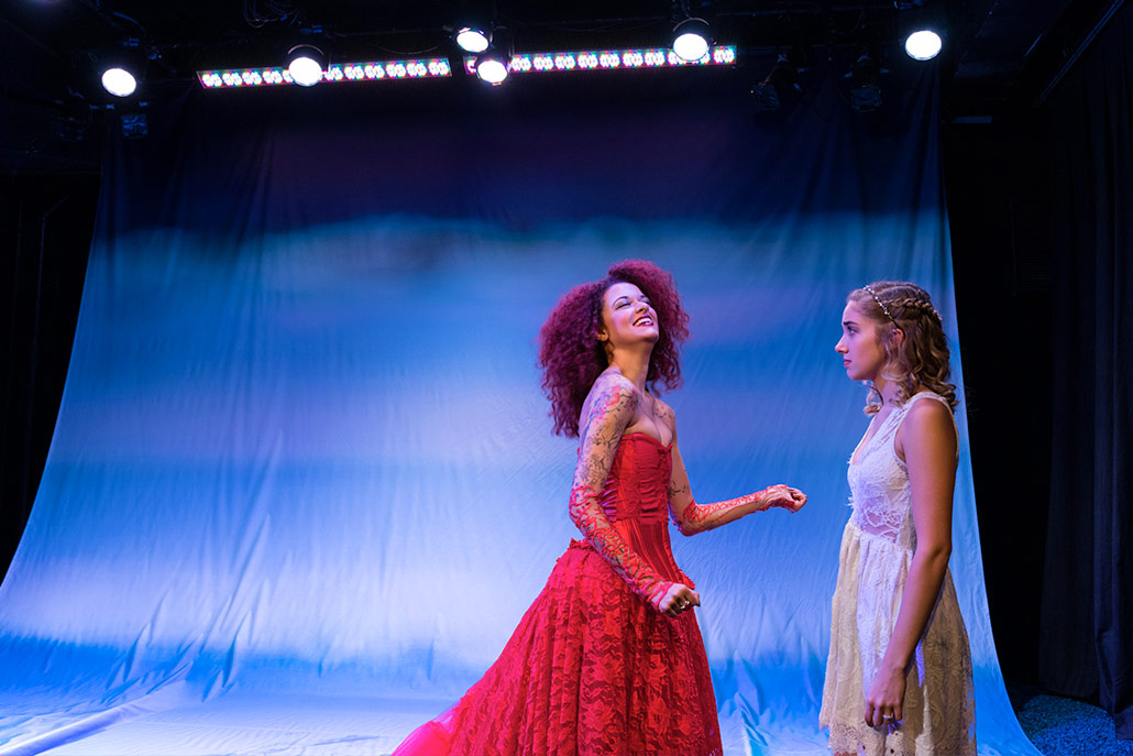 New York Film Academy musical theatre students in red and white lace dresses perform Eurydice.
