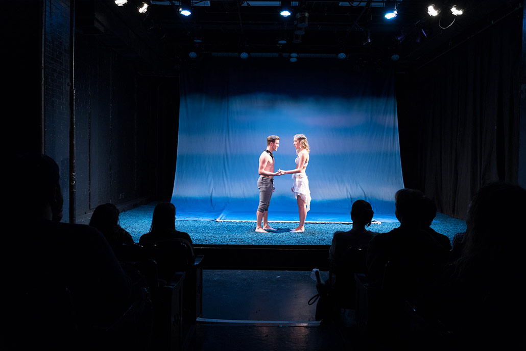 Over-the-shoulder view from audience perspective watching NYFA musical theater performers in Eurydice.