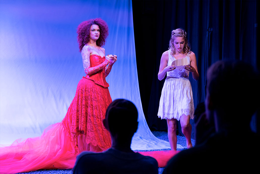 NYFA musical theatre student in glamorous red lace costume performing in Eurydice.