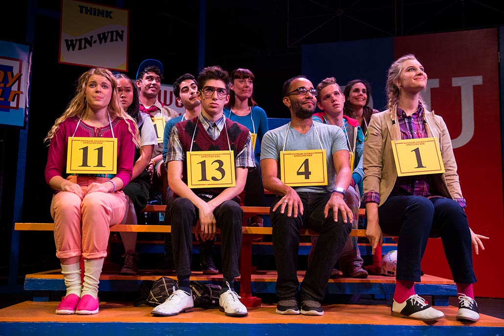 NYFA musical theatre student ensemble siting in bleachers in scene from Spelling Bee.