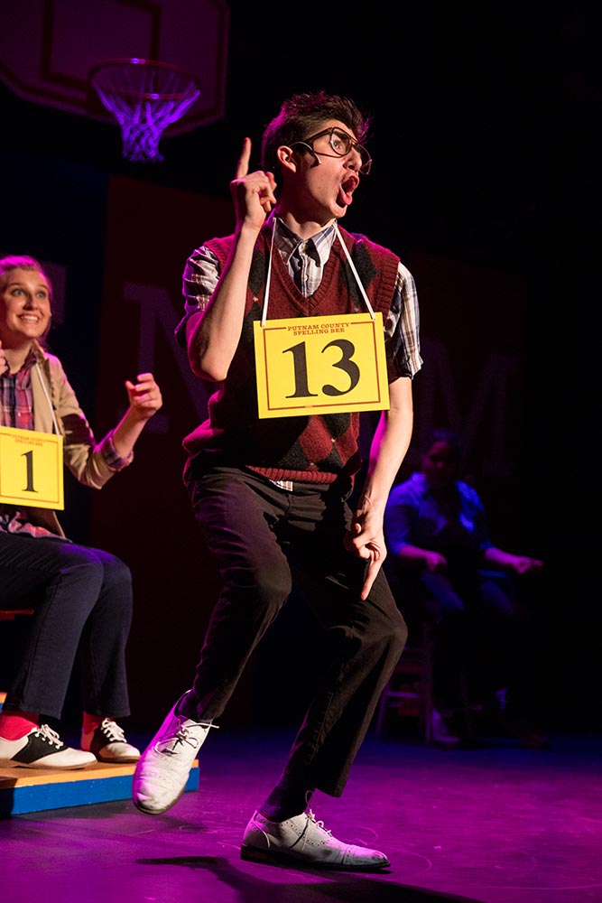NYFA musical theatre performer wearing 13 sign sings in Spelling Bee.