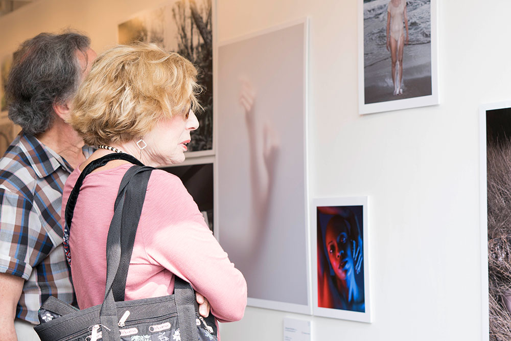 Man and woman viewing photo exhibit