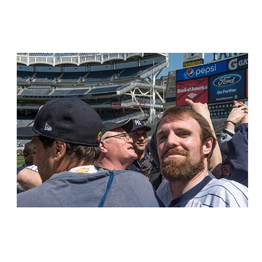 Man taking photo of himself at New York Yankee baseball game