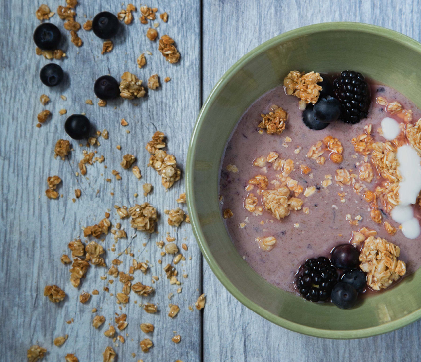 Yogurt, granola and fruit on wood table