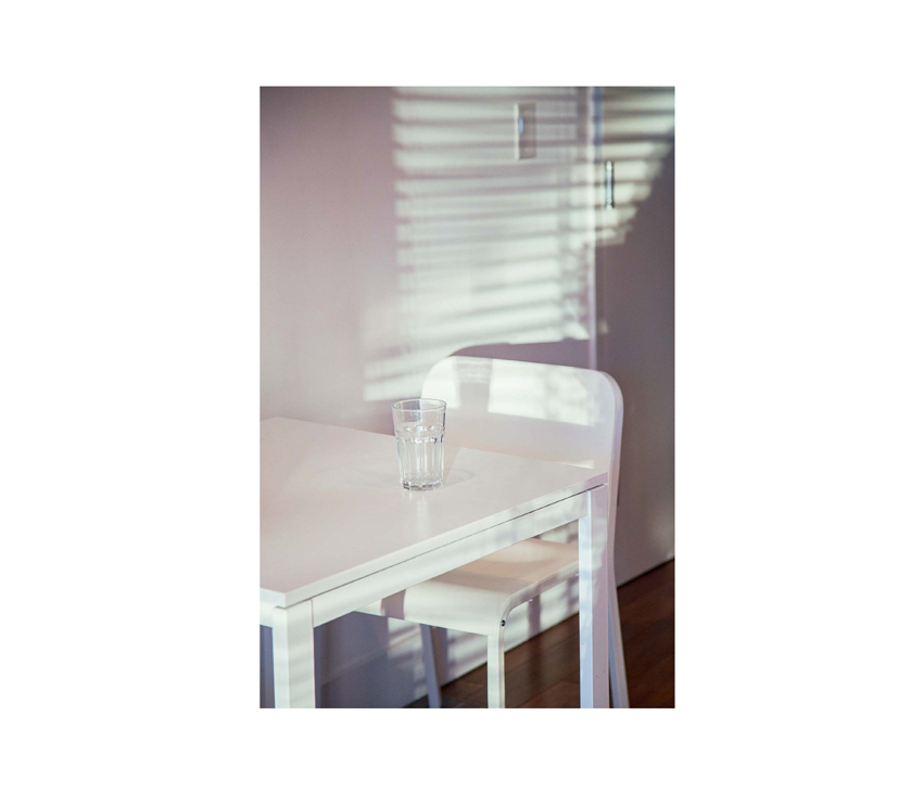 Empty glass sitting on white kitchen table