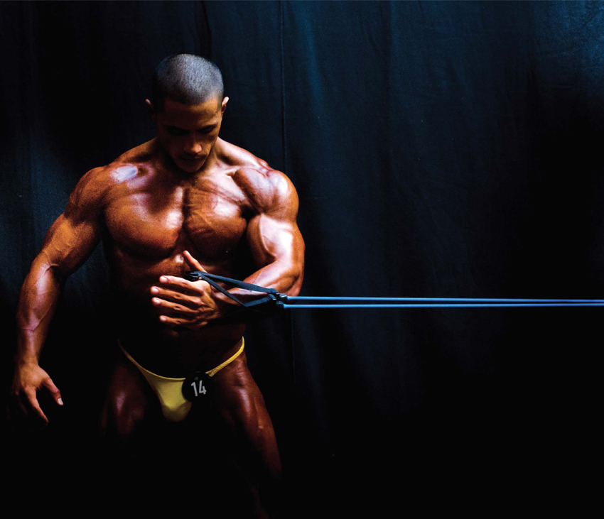 Bodybuilder using resistance bands while working out