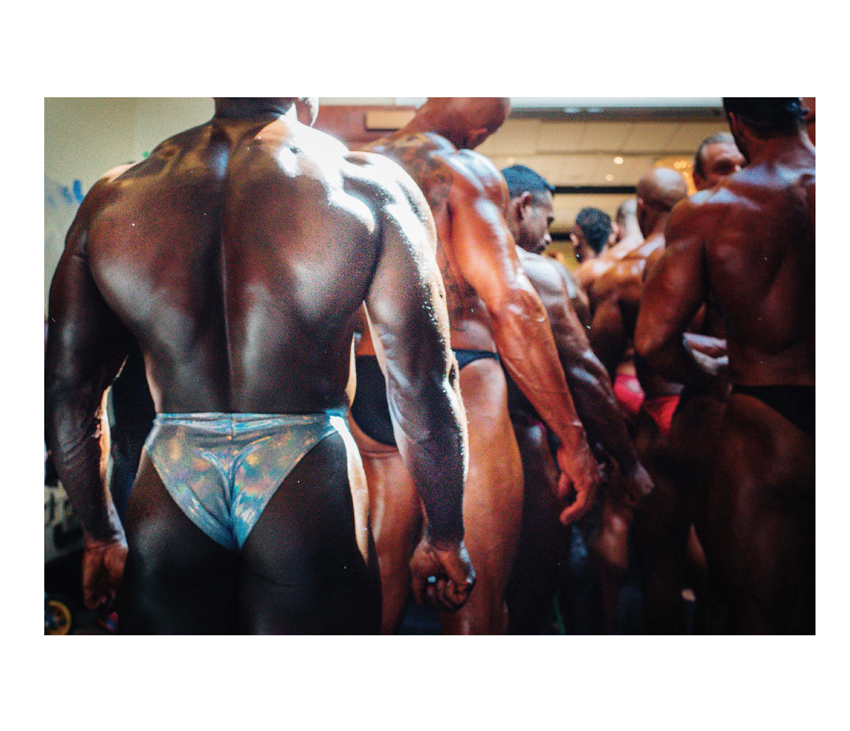 Bodybuilders lined up for competition in uniforms