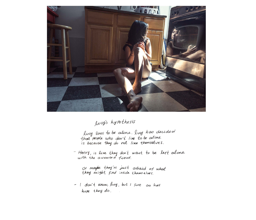 ﻿Woman sitting on floor of kitchen looking away with poem under image