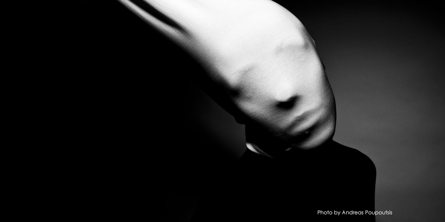 ﻿Black and white photo of model with face covered in fabric