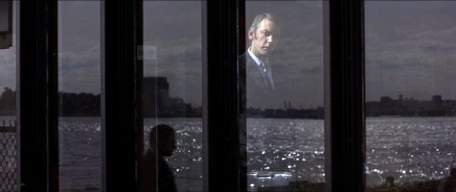 Donald Sutherland stares out the window in Klute