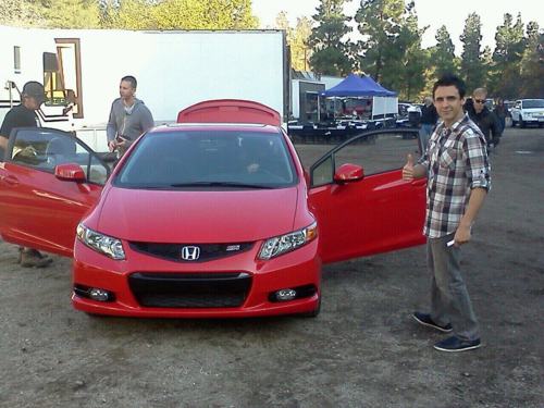 Beto posing in front of a Honda
