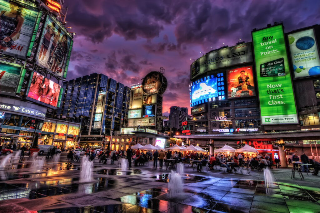 This is Toronto's Yonge-Dundas Square, which reminds me of Times Square in NY. I spent a couple of hours here and was lucky to get a colorful sunset. This is an HDR of 3 shots (-2, 0, +2), tonemapped in Photomatix. In PS: - Imagenomic Noiseware twice, one stronger on the sky. For the next commands I masked the sky. - Smart sharpen - Freaky details masking - Nik Tonal Contrast - Vibrance increase on the whole image - A bit os saturation boost on the sky - Curves - Burn the top of the sky and the edges - A bit of Nik Glamour Glow.