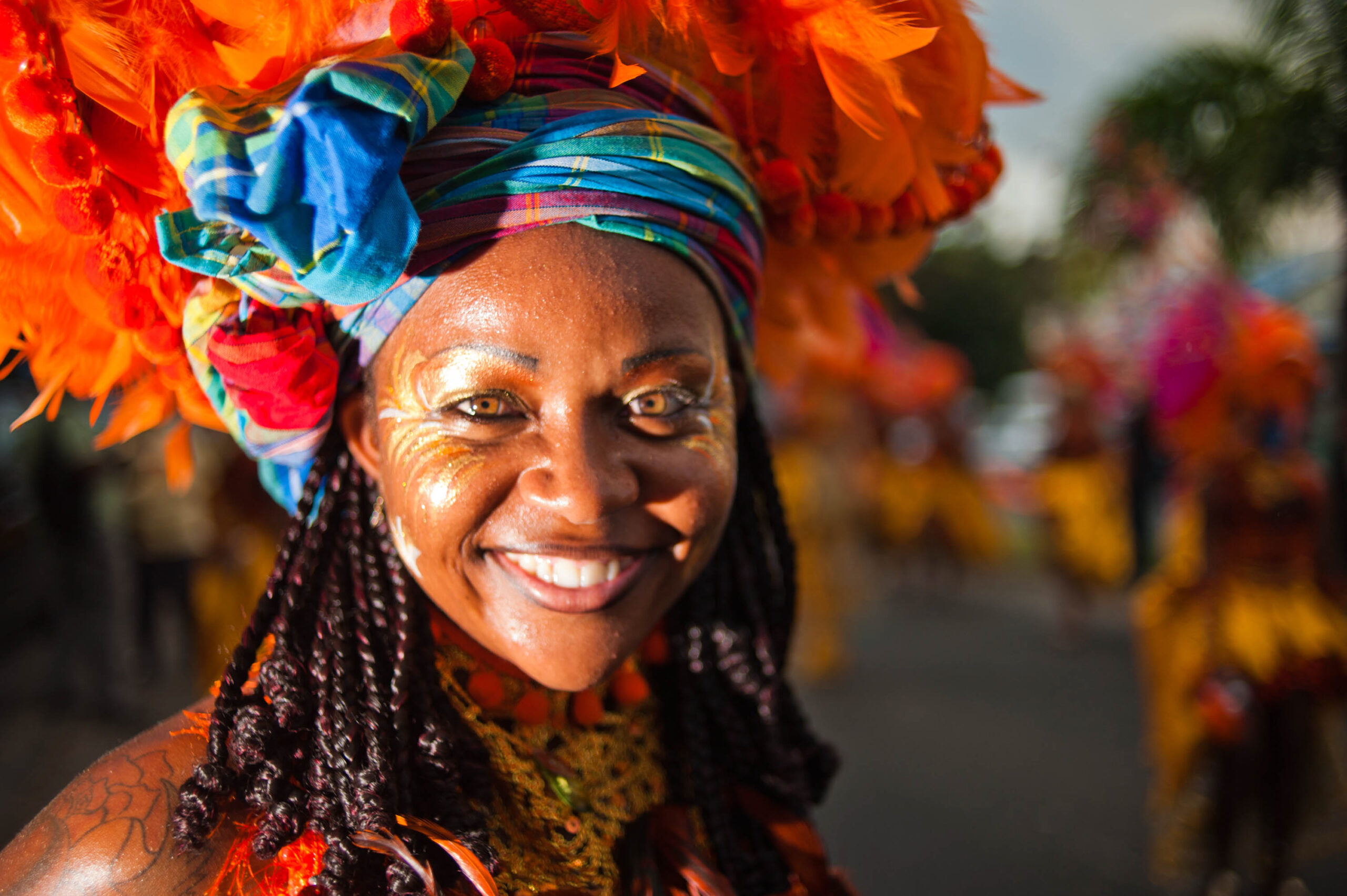 Guadeloupe winter carnival, Pointe-à-Pitre parade. A young woman, performer wearing traditional carnival head-dress(close up outdoor portrait).