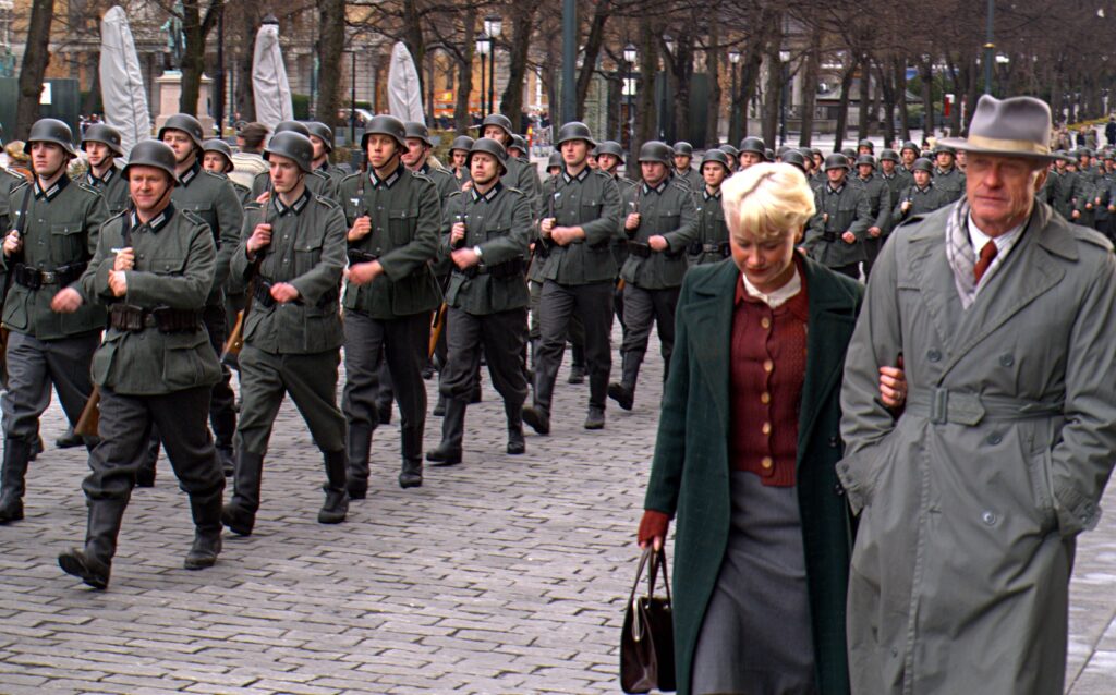extras march during a WWII scene
