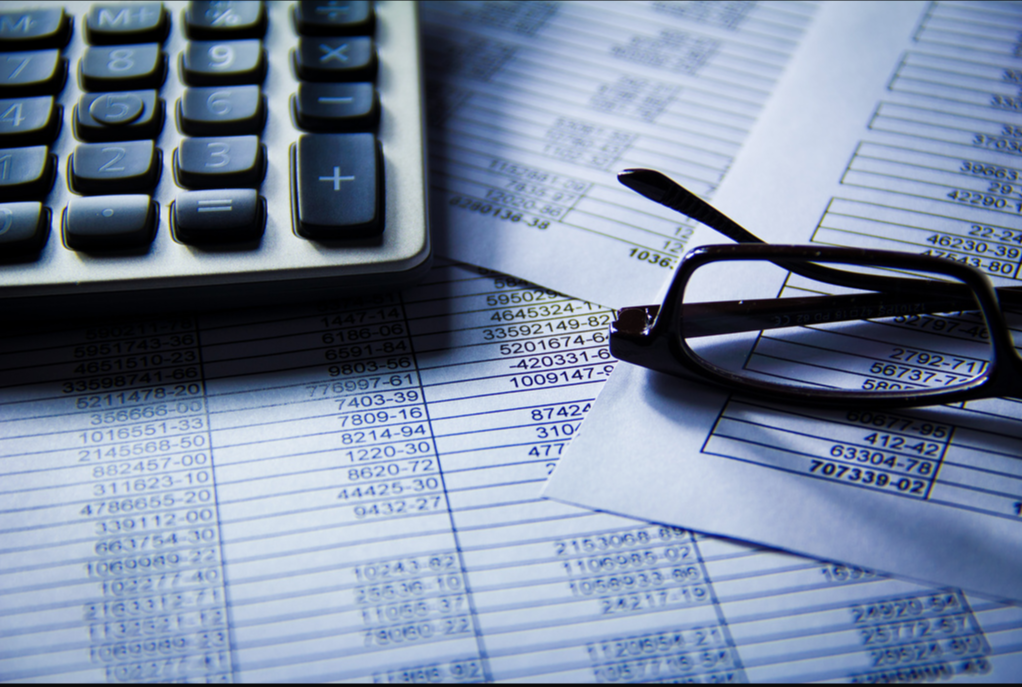 Picture of calculator, glasses, and papers