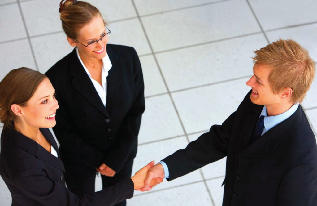 Businessman shaking hands with businesswoman