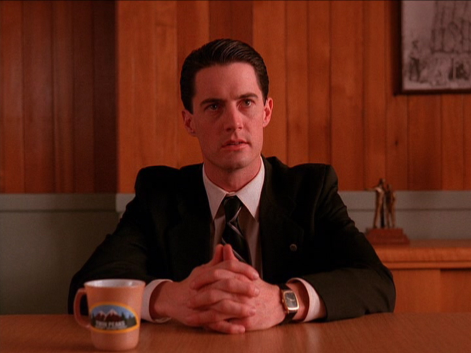 Agent Dale Cooper sitting with cup of coffee