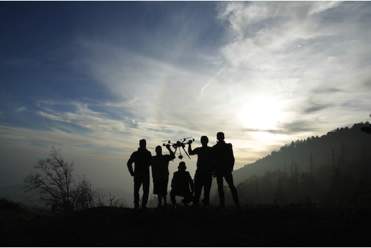 Team with aerial drone camera