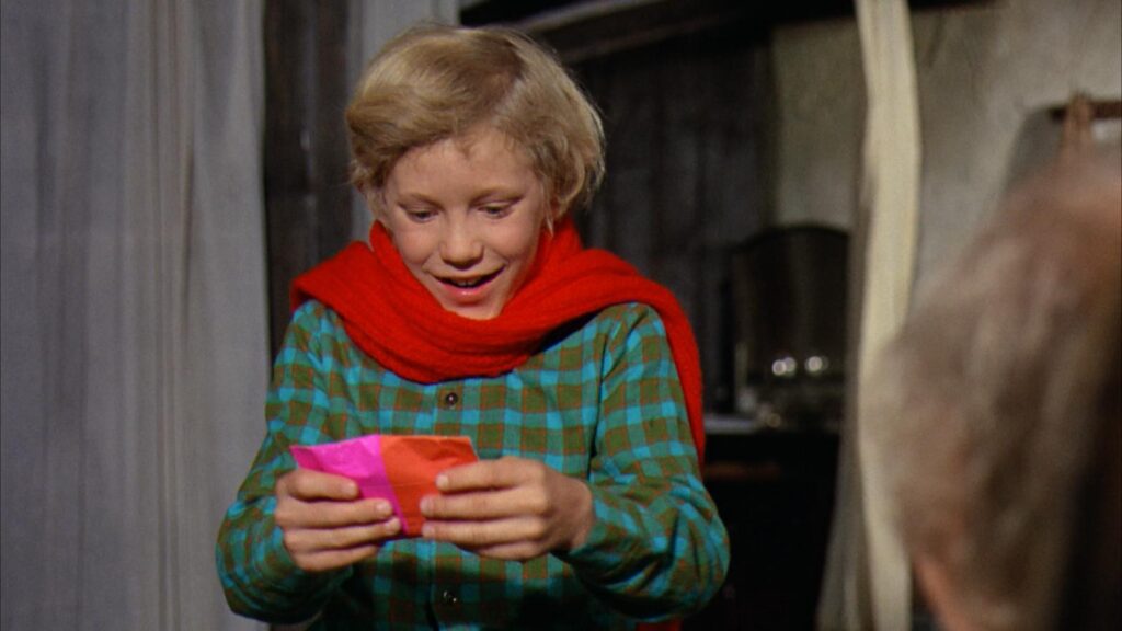 Peter Ostrum as Charlie with a Willy Wonka bar