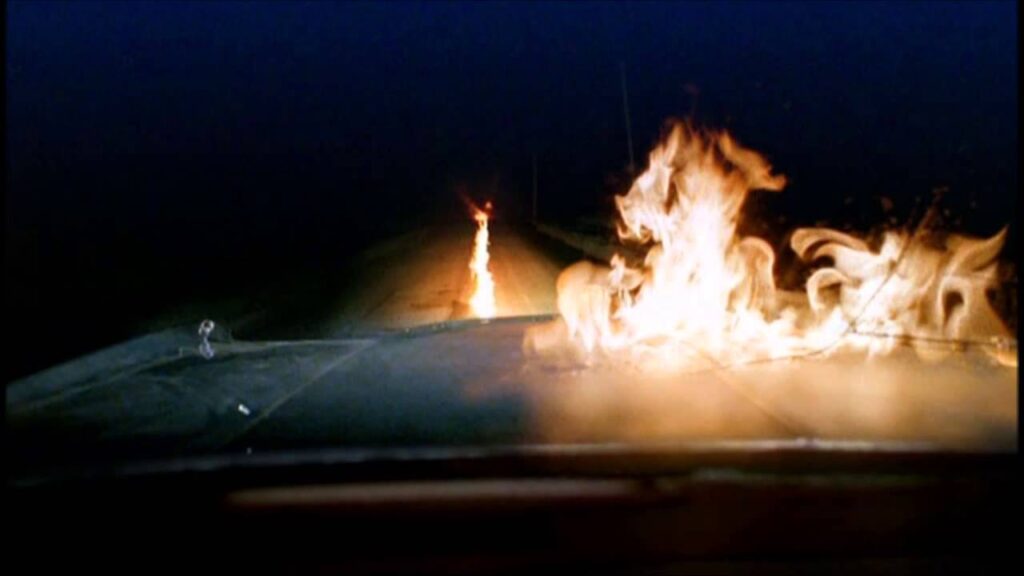 Karma Police screenshot of fire on road